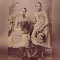 Foto van waarschijnlijk twee dochters van Aarnoud Willem van Beeck Calkoen en Pauline Albertine Ram, zittend op en staand tegen een bankje met een hond, ca. 1888. Bron: HUA, 1135, 387.